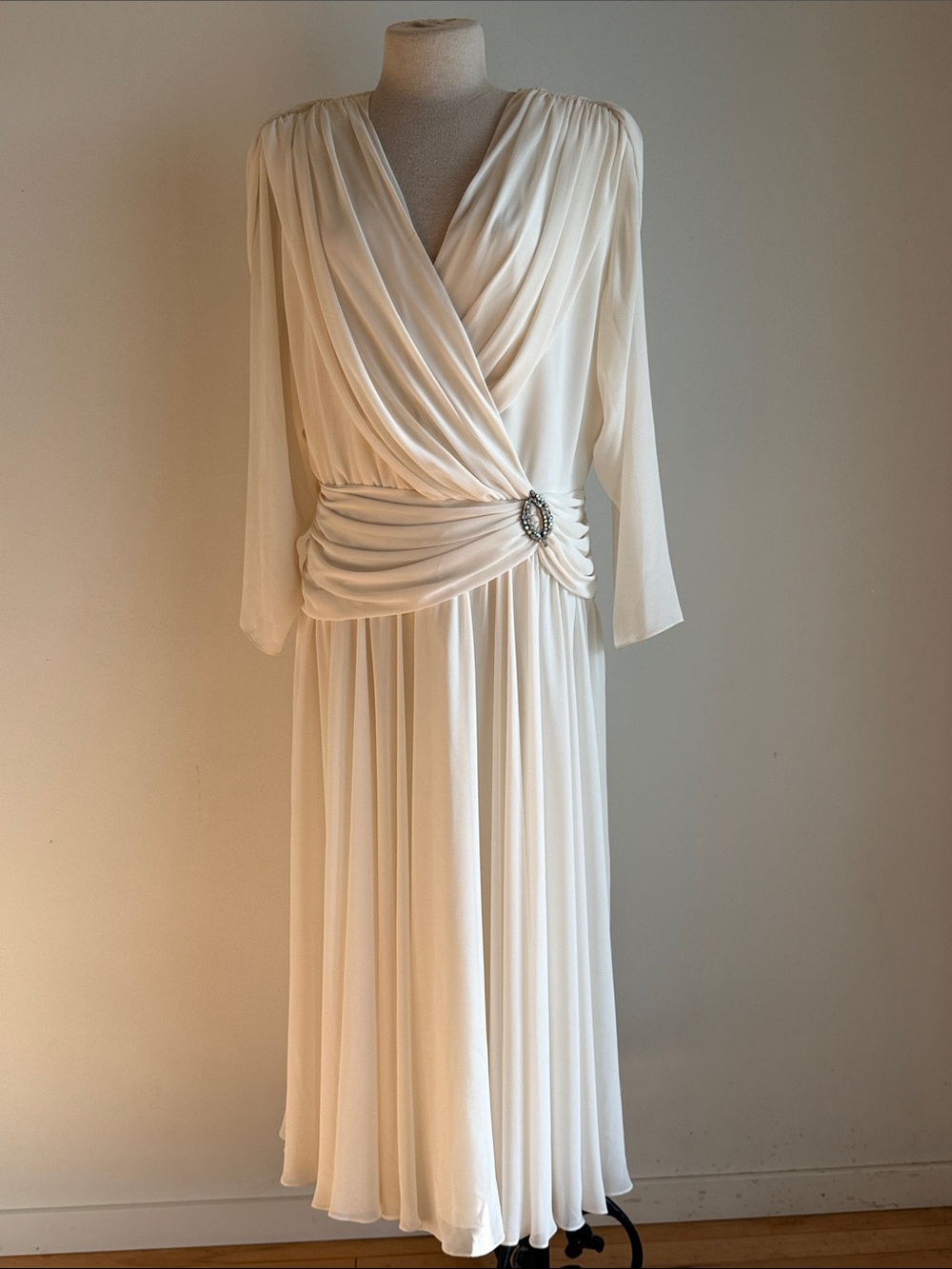 Elegant Cream Draped V-Neck Evening Dress with Decorative Brooch